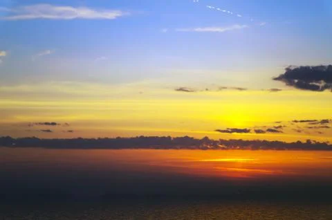 Sunset over cold ocean. Stock Photos