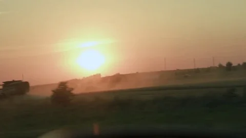 Sunset over a combine haverster  Video stock 79851549