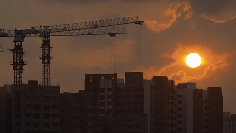 Sunset over construction site and public housing Stock Footage 93384090