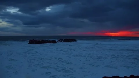 Sunset Over Crashing Waves and Rocky Coastline Stock Footage 320202344