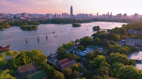 Sunset over Daming Lake, Jinan: Traditional Charm Meets Modern Cityscape Stock Footage 331118031