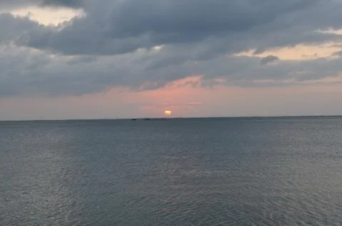 Sunset over Dark Water with Clouds Foto stock