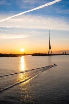 Sunset over the Daugava river. Riga old town panorama and TV tower Stock Photos