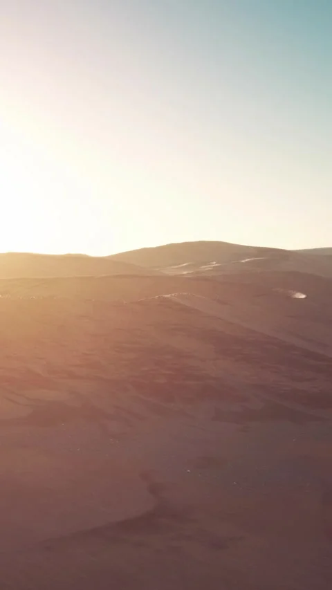 Sunset over desert landscape with hills and soft shadows in background Stock Footage 336982016