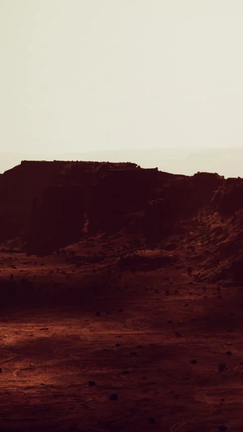 Sunset over desert landscape with rock formation in the background Stock Footage 338000249