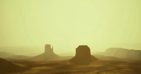 Sunset over the desert landscape showcasing rock formations at dusk Ilustração Stock