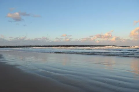 Sunset over a deserted beach. Stock Photos