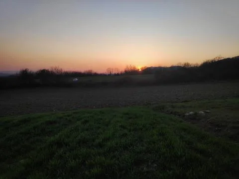 Sunset over Distant Field Stock Photos