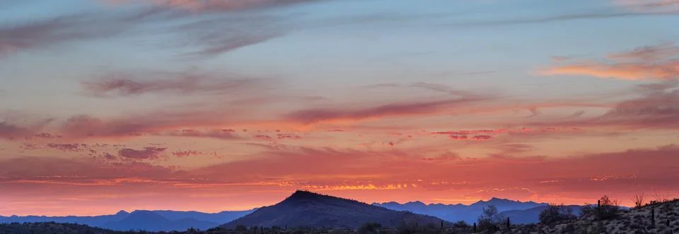 A sunset over a distant mountain 스톡 사진