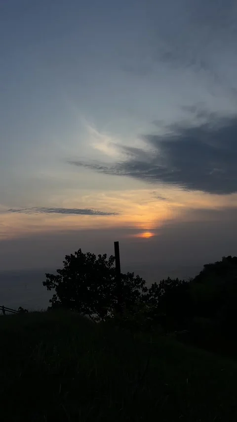 Sunset Over Distant Ocean, Hilltop Landscape, Vertical Static Shot Video stock 324772417