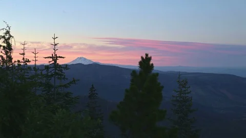 Sunset over distant snowy mountain and forest Mt. Adams Washington from Lost Stock Footage 81903423
