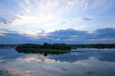 Sunset over Dnipro River with clouds and reflections in Kamianske, Ukraine Stock Photos