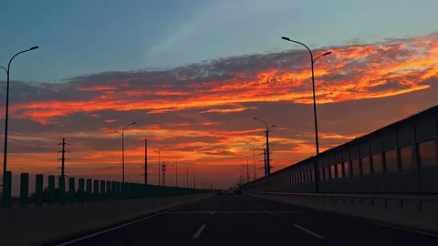 Sunset over the driving highway Stock Footage 252436243