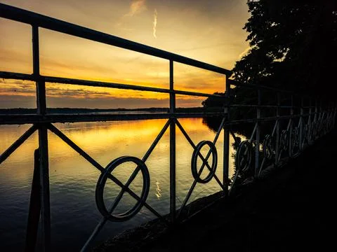 Sunset over Elbe river with railing silhouette in Torgau Germany Stock Photos