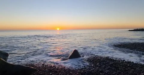 Sunset Over an Empty Sandy Beach Stock Photos