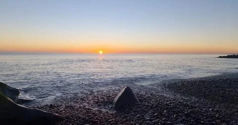 Sunset Over an Empty Sandy Beach Stock Photos