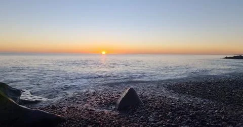 Sunset Over an Empty Sandy Beach Stock Photos