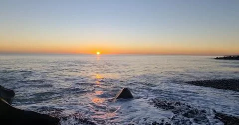 Sunset Over an Empty Sandy Beach Stock Photos
