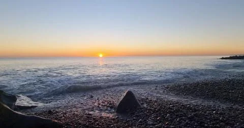 Sunset Over an Empty Sandy Beach Stock Photos