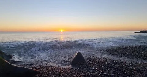 Sunset Over an Empty Sandy Beach Stock Photos
