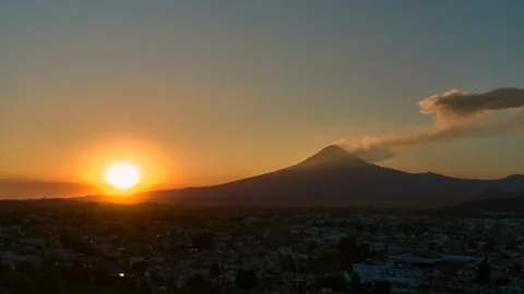 Sunset over the exploding Popocatpetl volcano, from Cholula,time lapse 動画素材 235690445