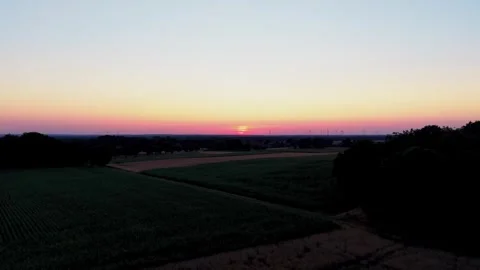 Sunset over farmland with wind farm Stock Footage 340919992