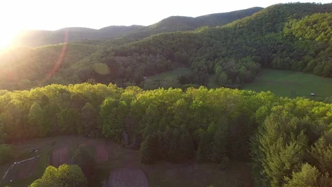 Sunset Over a Field in the Mountains Stock Footage 128546222