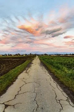 Sunset over fields and Austrian village with dramatic sky and colorful clouds. Stock Photos