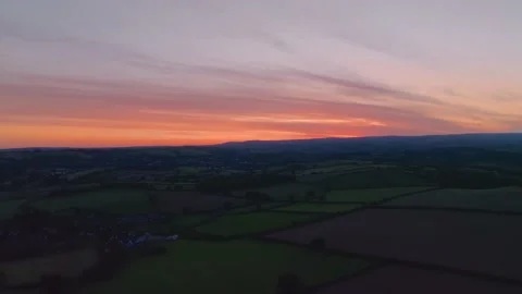 Sunset over Fields and Farms from a drone, Berry Pomeroy, Devon, England 動画素材 220658127