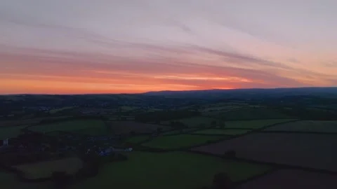 Sunset over Fields and Farms from a drone, Berry Pomeroy, Devon, England Stock Footage 220658209