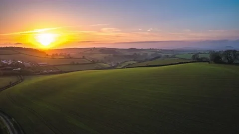 Sunset over Fields and Farms in HYPERLAPSE from a drone, Devon, UK Stockbeeldmateriaal 221156569