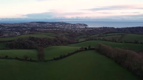 Sunset over Fields and Farms of Torquay and Paignton from a drone, Devon, UK Stock Footage 225878389