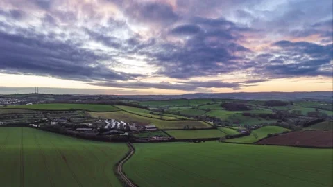 Sunset over Fields and Farms in HYPERLAPSE from a drone, Devon, UK 動画素材 228951818