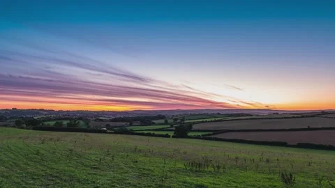 Sunset over fields and farms in timelapse, Devon, England, Europe 動画素材 232249996