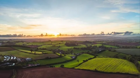 Sunset over Fields and Farms in Hyperlapse from a drone, Devon, England 動画素材 258041101