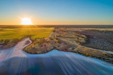 Sunset over fields and lake in Australia Stock Photos