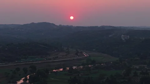 Sunset over fields and a river in rural India  Stock Footage 305258736