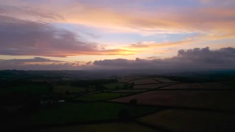 Sunset over the fields from a drone, Berry Pomeroy Village in Devon, England Video stock 161792191