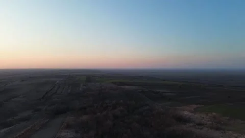 Sunset Over Fields with Wind Turbines – Smooth Left to Right Drone Shot Video stock 331996099