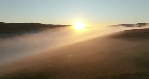 Sunset over foggy fields Stock Footage 296664371