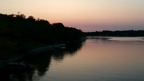 Sunset over a Forest and Lake Vertical Aerial Shot Stock Footage 145241251