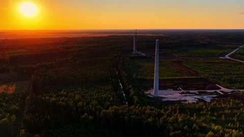 Sunset Over Forest with Majestic Wind Turbines in Serene Landscape Video stock 333327337