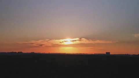 Sunset over the forest, the sun sets behind the city and the trees in the park Stock Footage 155851673
