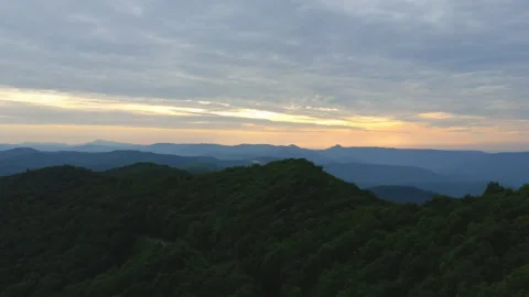Sunset over forested mountains aerial view Stock Footage 328964277