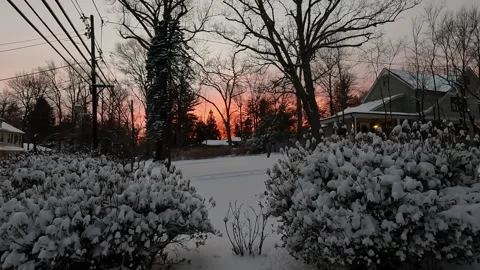 Sunset over front yard covered with snow in January Stock Footage 321430831