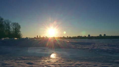 Sunset over frozen river Stock Footage 98311969