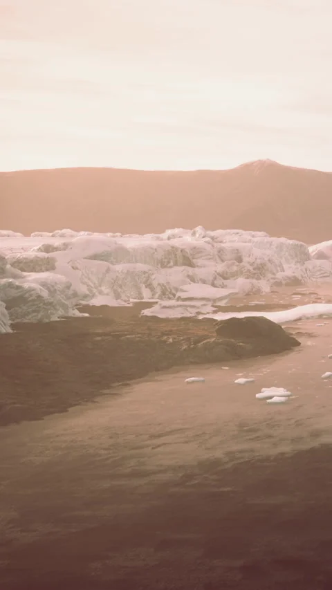 Sunset over a glacier with icebergs and mountains in the background Stock Footage 340283782
