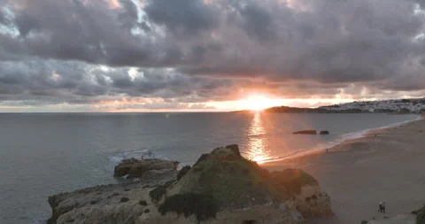 Sunset over golden cliffs and sandy beach in Albufeira Algarve Stock Footage 346651386