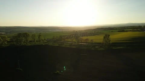 Sunset over green fields and countryside road Stock Footage 307938480