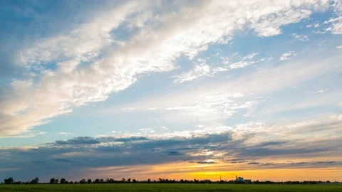 Sunset over a green wheat field and a metallurgical plant, timelapse, 4k Stock Footage 131041329